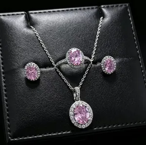 Detailed view of pink oval gemstone jewelry set including necklace, ring, and earrings