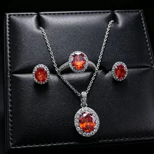 Elegant red oval gemstone jewelry set including necklace, ring, and stud earrings