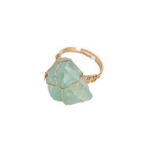 Handmade wire wrapped adjustable ring with a large irregular green natural raw stone