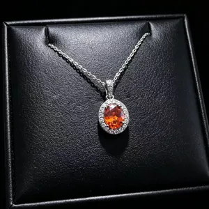 Close-up of elegant oval orange moissanite gemstone pendant necklace in black gift box