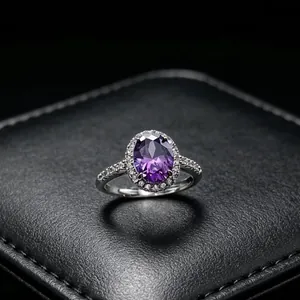 Close-up detail of an elegant oval purple moissanite ring with a sparkling halo setting