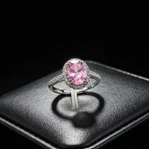 Detailed view of an oval pink moissanite ring in a halo setting with a heart shadow