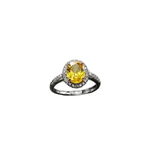 Elegant classic halo ring featuring a large oval yellow stone and sparkling side accents