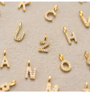 Detailed macro view of S925 sterling silver alphabet pendants with pavé zircon stones