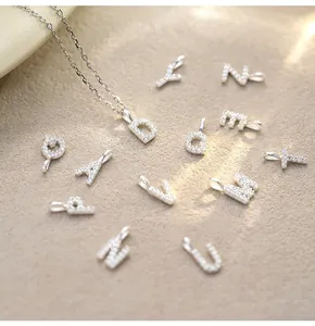 Detailed macro view of S925 sterling silver letter pendants with sparkling crystals