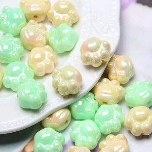 Close-up macro view of iridescent cat paw acrylic beads for DIY jewelry making and craft projects