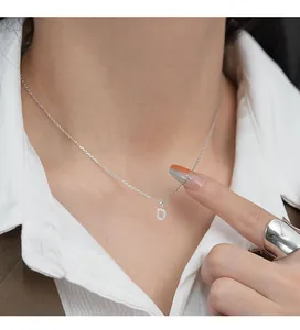 Close-up detail of S925 silver necklace with sparkling rhinestone initial D pendant