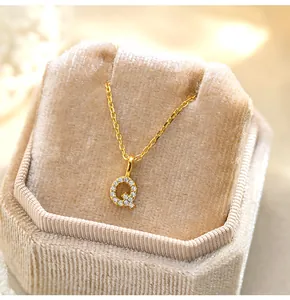 Detailed view of a gold S925 silver necklace with a sparkling paved letter Q pendant.
