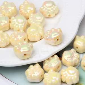 Detail macro view of iridescent cream cat paw acrylic beads for DIY jewelry making