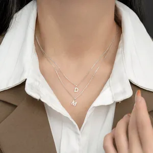 Elegant S925 sterling silver pave initial necklace featuring layered D and M letter pendants