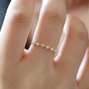 Anello minimalista in argento s925 placcato oro 14K con piccoli zirconi indossato sul dito