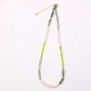 Detailed macro view of a light luxury natural pearl and green crystal splicing necklace