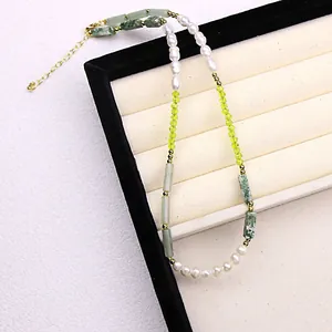 Detailed view of luxury natural pearl necklace featuring green crystal and stone beads