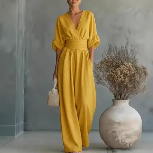 Elegant yellow V-neck jumpsuit with cinched waist and wide-leg design for summer