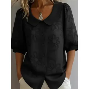 Elegant black floral embroidered blouse with Peter Pan collar and casual puff sleeves.