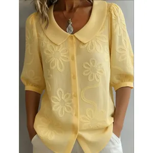 Elegant vintage yellow women's blouse featuring floral embroidery and a Peter Pan collar design