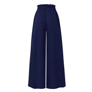 Detail of navy blue high-waisted wide-leg palazzo pants with elastic waistband.