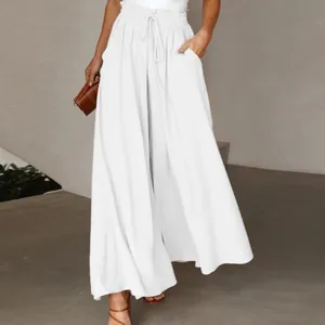 Detail of white wide-leg trousers featuring a high elastic waist with a drawstring tie.