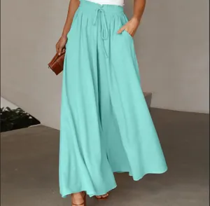 Detailed view of high-waisted teal wide-leg pants with elastic drawstring waist.