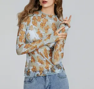 Detailed view of women's sheer floral mesh long sleeve top with intricate lace texture