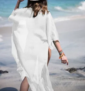 Elegant back view of white chiffon beach cover-up on a sunny tropical beach setting