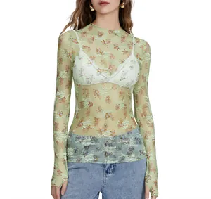 Detailed view of women's sheer floral lace mesh top with long sleeves and high neck