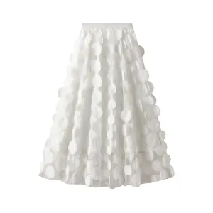 Detailed view of the 3D floral mesh texture on this white high-waisted A-line skirt.