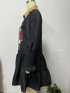 Side detail of black Christmas dress with nutcracker embroidery and tiered skirt