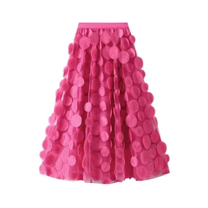 Detailed view of magenta A-line mesh skirt with intricate 3D floral circle appliqués