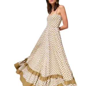 Detail view of the checkered maxi dress showing the large swing skirt and ruffled hem