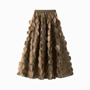 Detailed view of a brown mesh midi skirt featuring elegant 3D circular floral appliqués