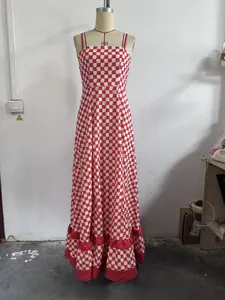 Red and white checkered maxi dress with spaghetti straps and ruffled tiered hem on mannequin.