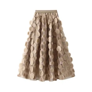 Elegant detailed view of 3D floral appliques on a beige mesh A-line midi skirt fabric.