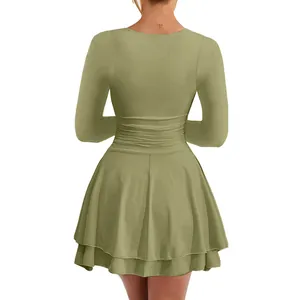Back view of sage green long sleeve mini dress with double-layered pleated hem and waist