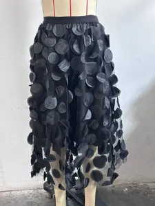 Detailed view of women's black high-waisted A-line mesh skirt with 3D industrial floral petals