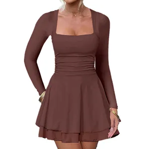 Detail view of a brown long-sleeved mini dress with a square neck and pleated hem.