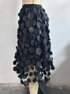 Exquisite detail of black high-waisted A-line skirt with 3D mesh floral appliques