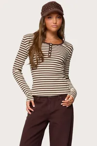 Close-up of a women's brown and cream striped henley long sleeve T-shirt with button detail