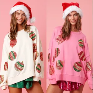 Deux pulls de Noël festifs avec sequins pour femmes en couleurs crème et rose.