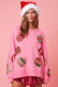Vue détaillée du sweat de Noël rose avec broderie de paillettes festives ornement