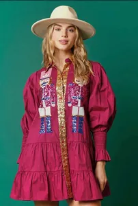 Magenta Christmas mini dress featuring sequined nutcracker patterns and puffed sleeves