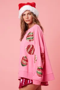 Détail du sweat de Noël rose avec ornements en paillettes pour femme mode fêtes