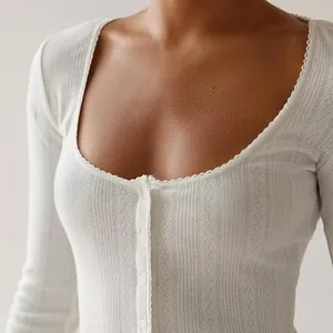 Detailed view of a white French style pointelle knit top featuring a delicate scalloped trim.