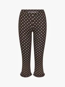 Close-up of brown polka dot cropped pants featuring a delicate ruffle hem detail