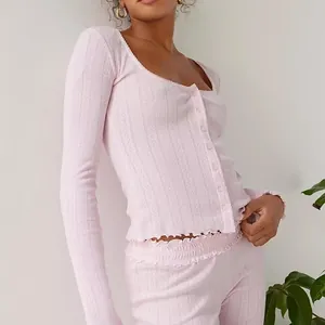 Detail of French style pink ribbed loungewear set with lettuce trim and buttons