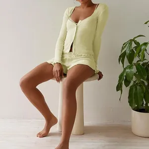 Elegant mint green ribbed knit lounge set featuring lettuce edge details on a model