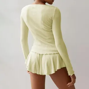 Detailed back view of a light yellow ribbed knit loungewear set with ruffled lettuce trim