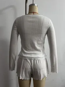 Detailed back view of a white ribbed knit lounge set featuring delicate ruffle trim edges
