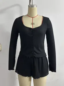 French style black ribbed knit two-piece set featuring delicate ruffled edges