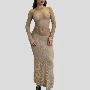 Detailed view of the sheer floral lace pattern and fit of the long sleeve crop top and skirt